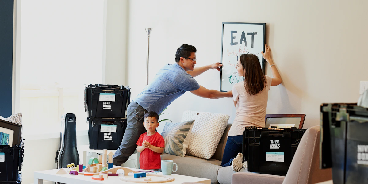 A family among moving boxes in a home